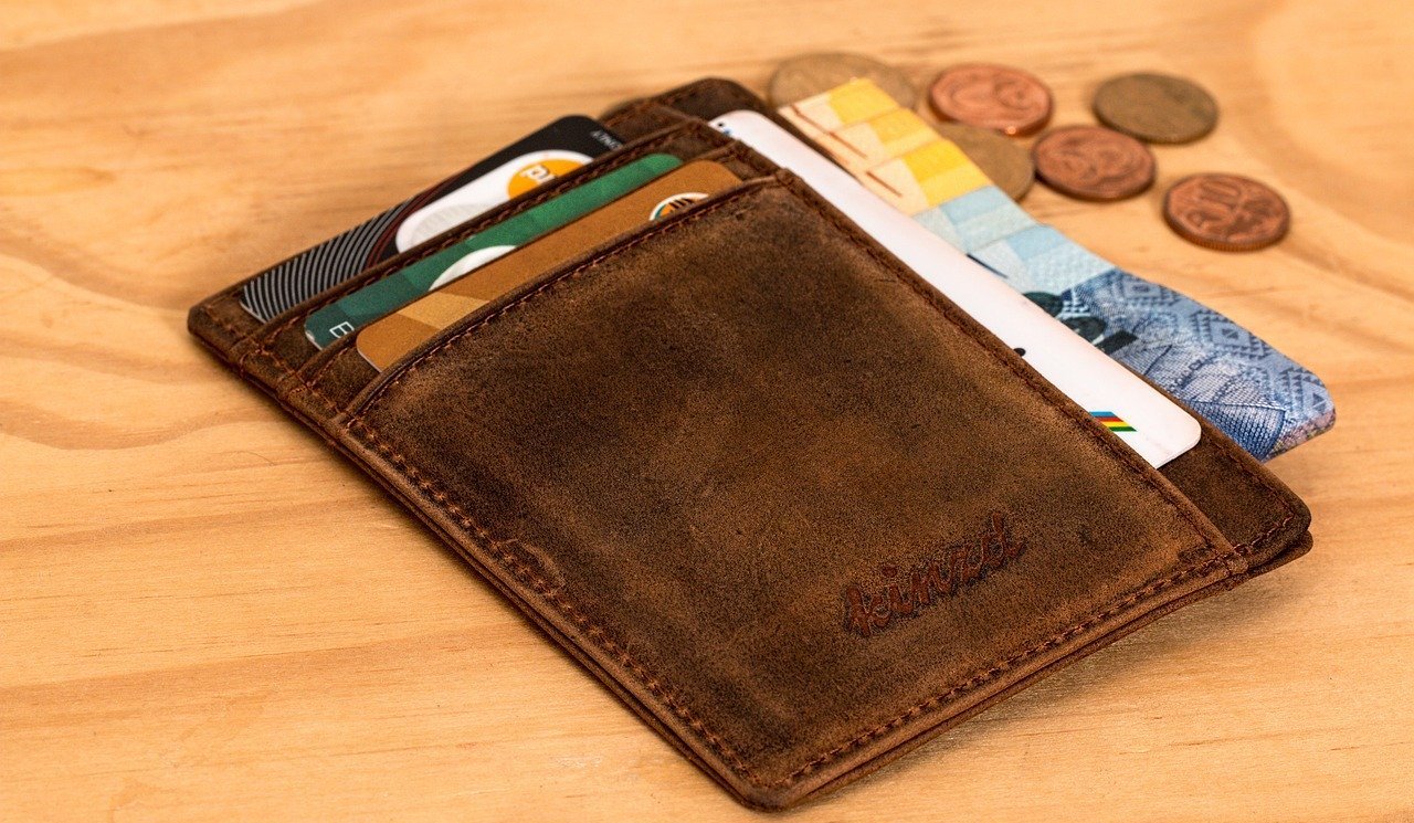 Card holder with coins on the side