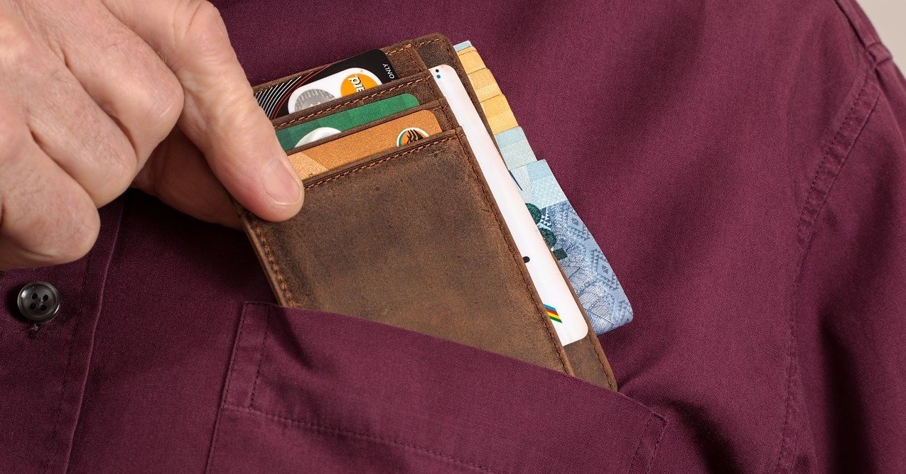 Man putting his card holder into his shirt pocket