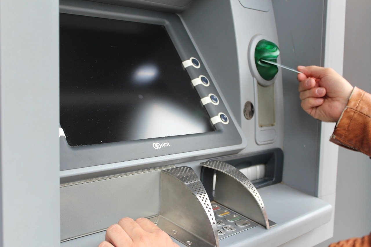 Person inserting their card on an ATM machine