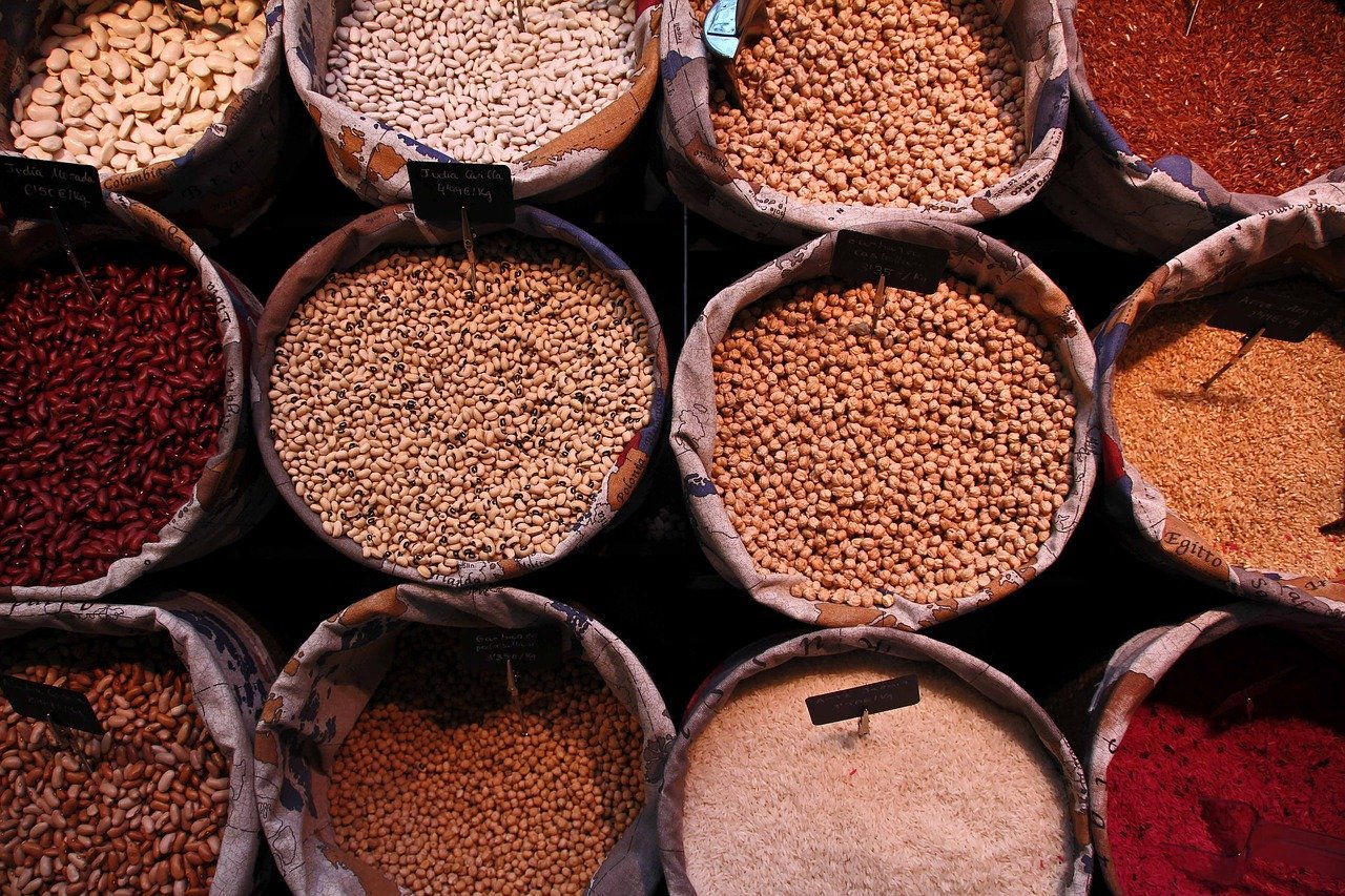 Spices in large containers displayed on a market