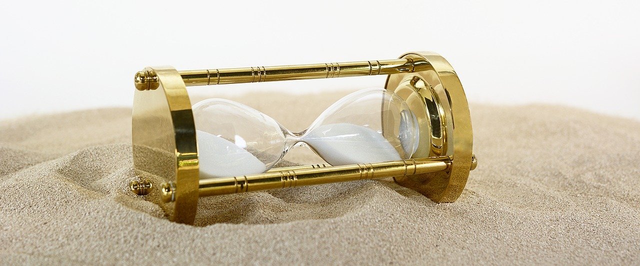 Vintage hourglass on top of sand
