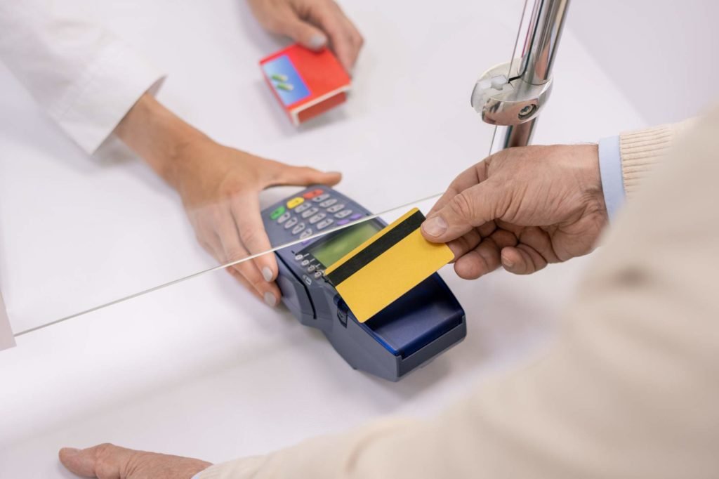 Man placing his credit card on a credit card terminal