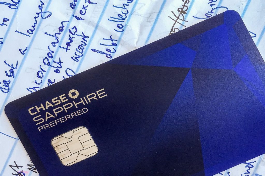 Chase Sapphire credit card on top of a notepad with scribbled writing