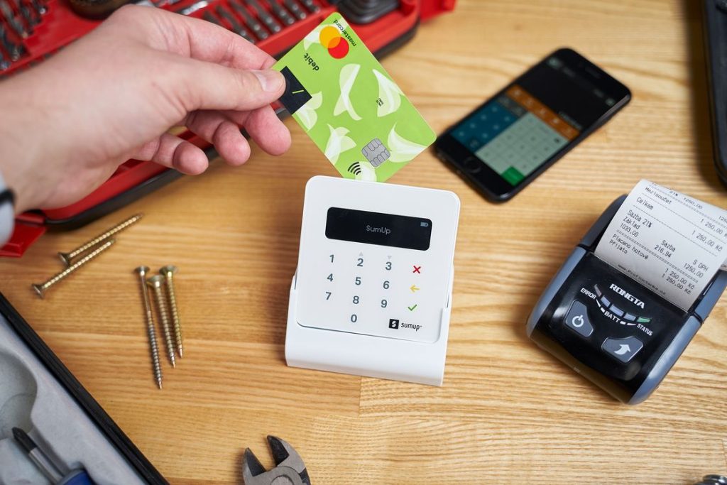 Person inserting a credit card into a card reader