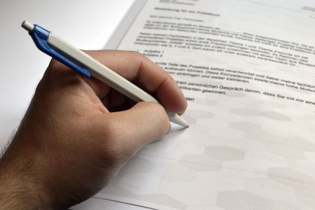 Man signing a printed document