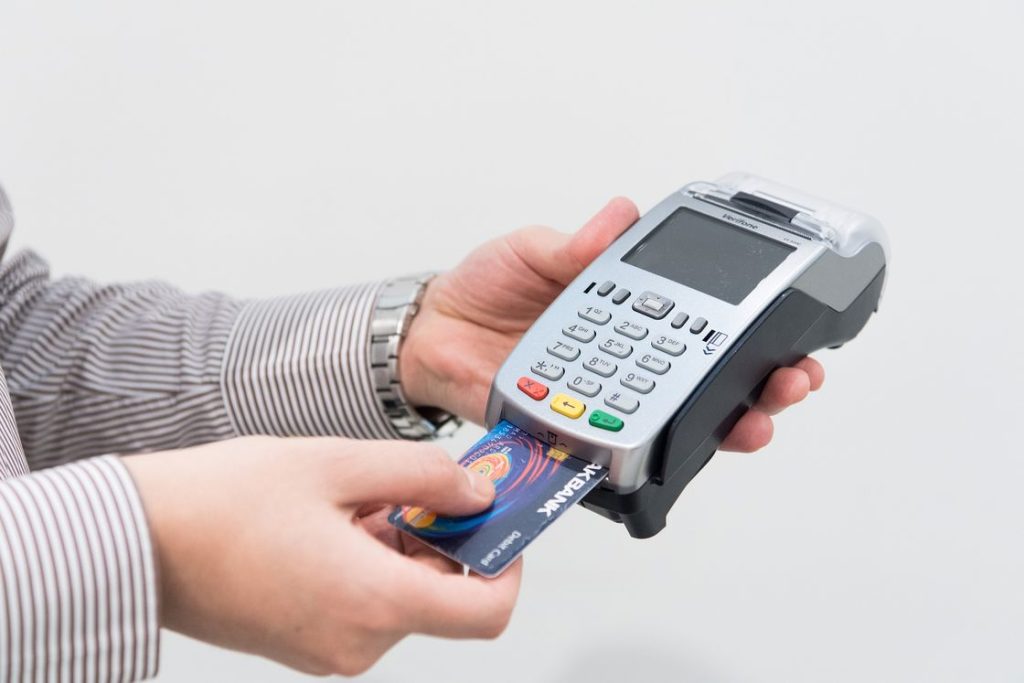 Man inserting a credit card on a portable machine