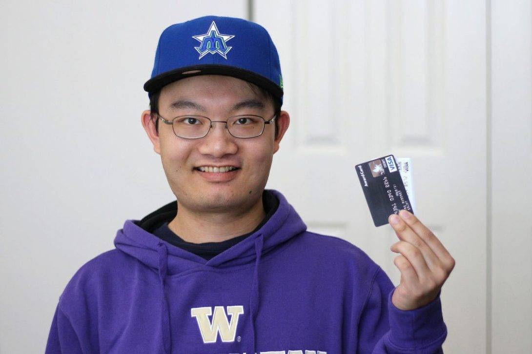 Young man holding two credit cards