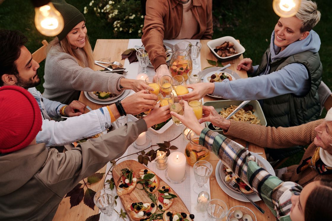 Family clinking their glasses for a toast on a dinner table