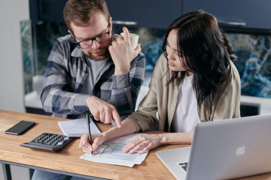 Couple filling out printed documents together