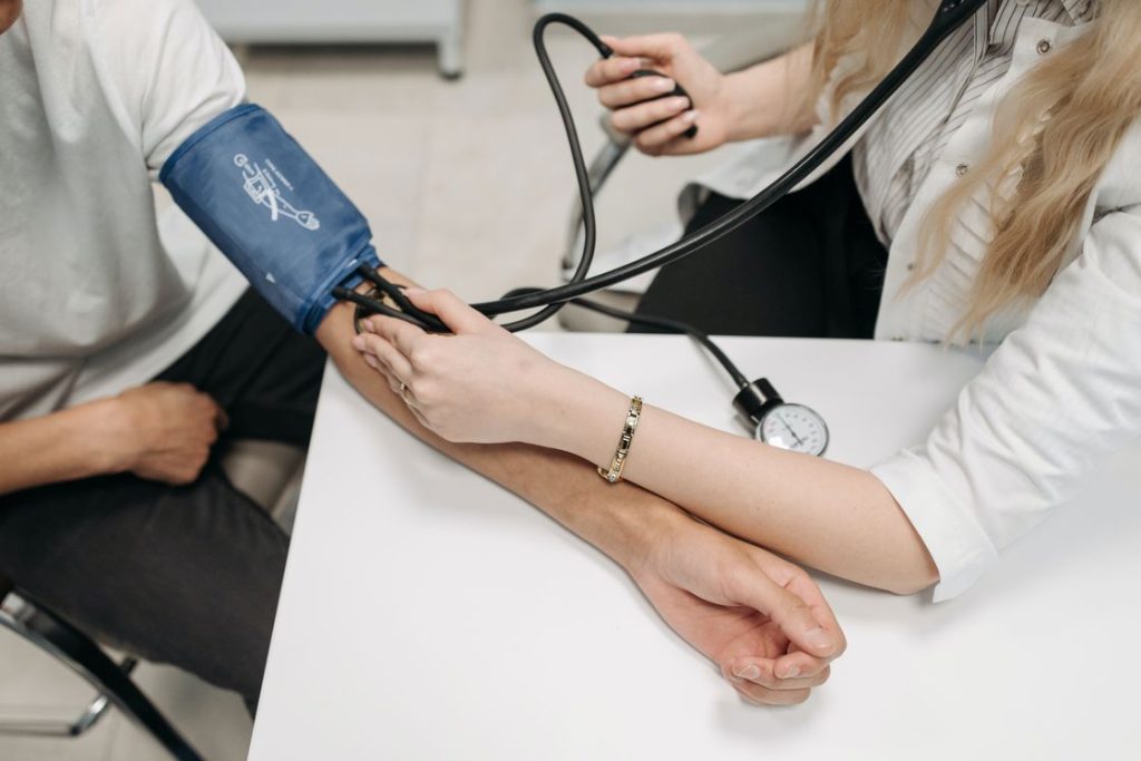 Doctor using the Sphygmomanometer on a patient