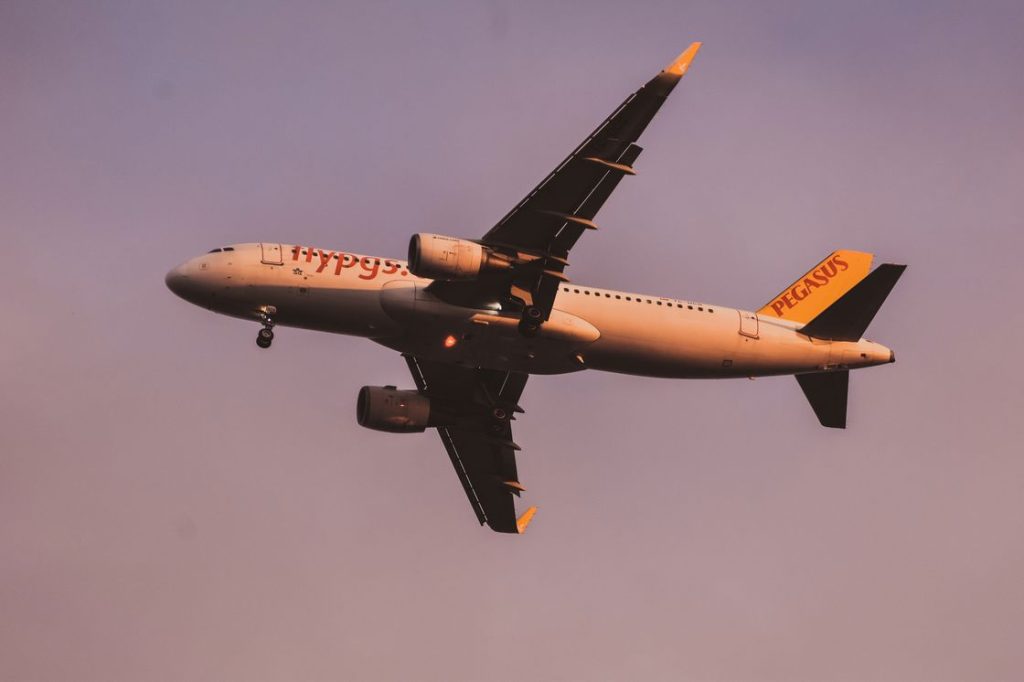 Airplane flying on a low land