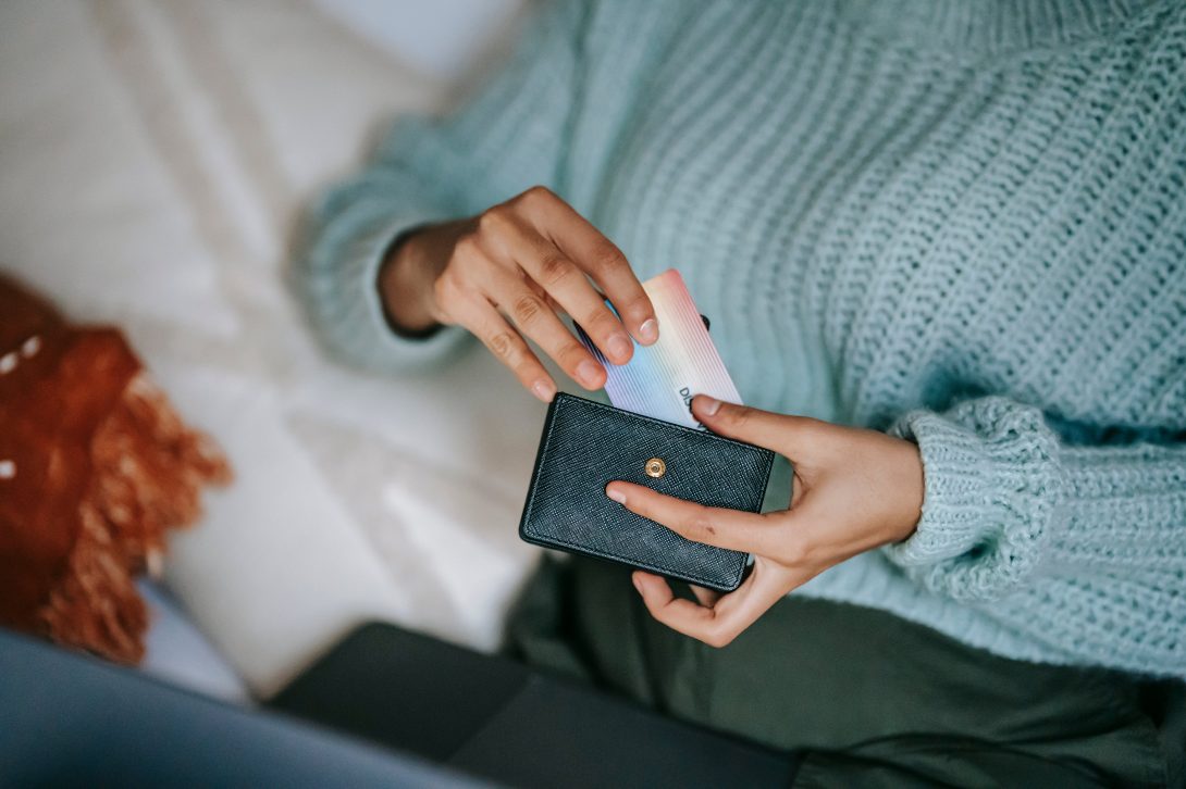 A woman getting a credit card on her wallet