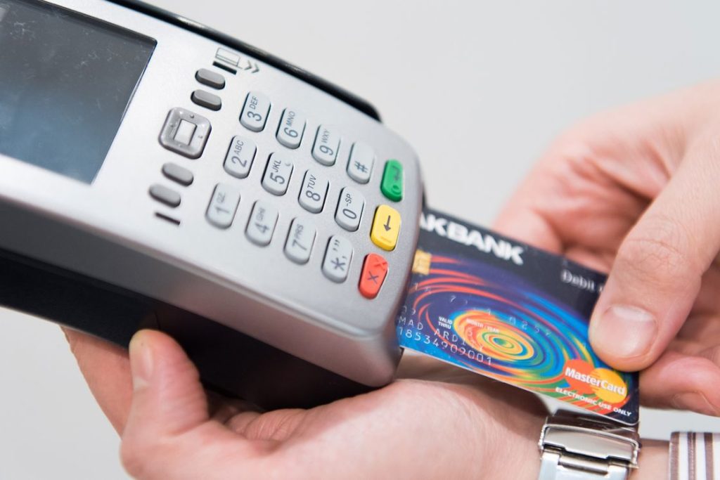 Person inserting a credit card on a payment terminal