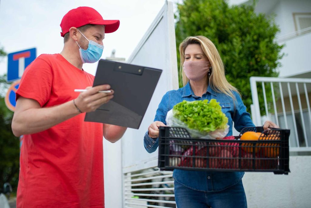 Delivery man showing the customer a checklist of the items they delivered