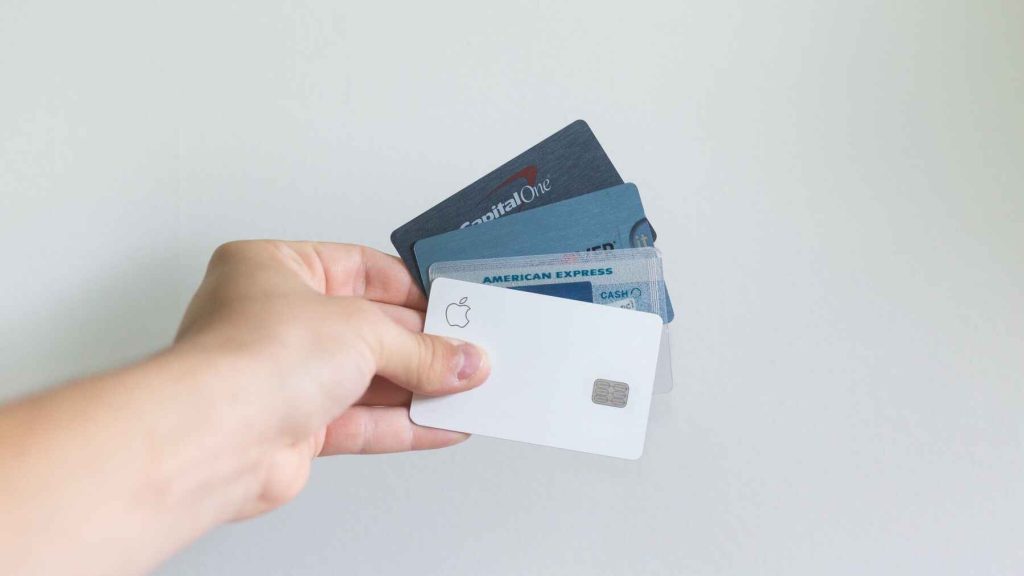 Person holding various kinds of credit cards