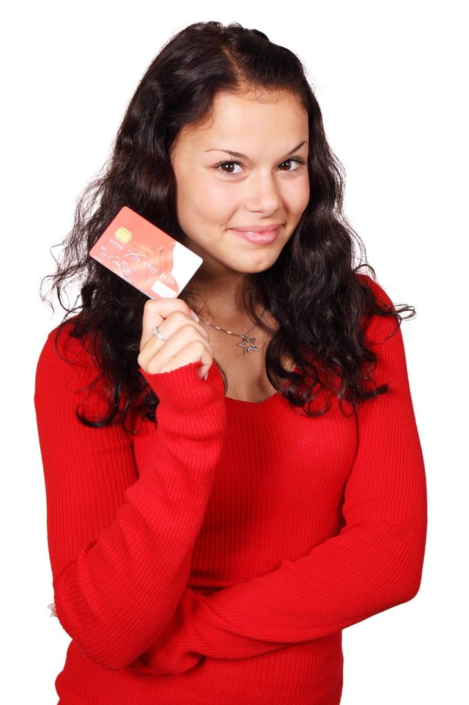 Young woman holding a credit card