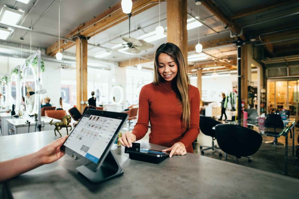 Woman swiping her card on a payment portal