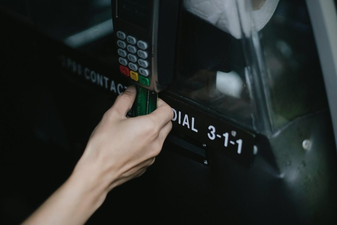 A woman swiping her card on a taxi's terminal payment