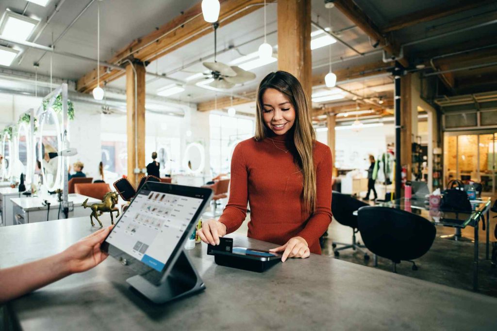 A woman paying on the cashier with her credit card