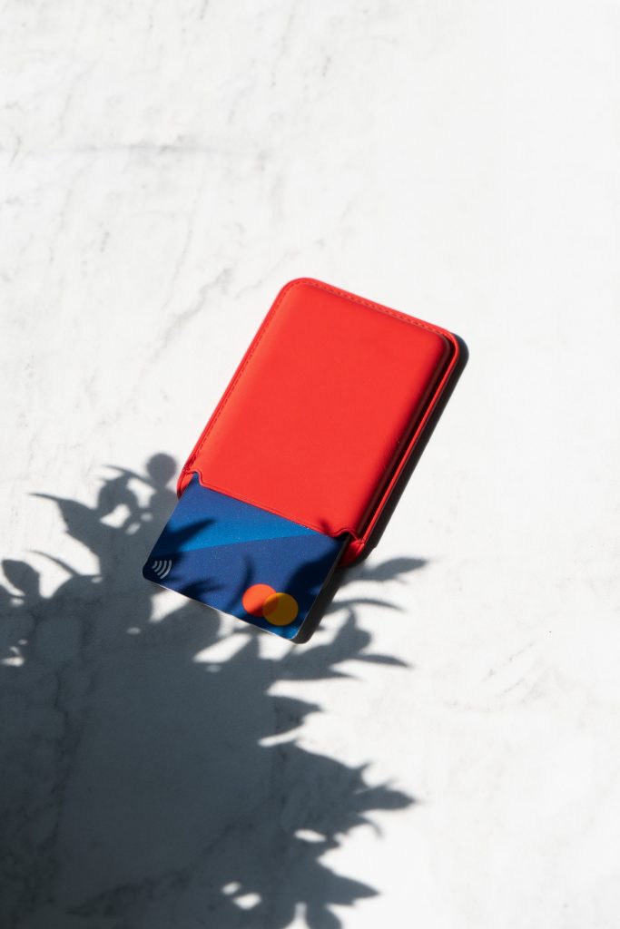 A red cardholder with a credit card