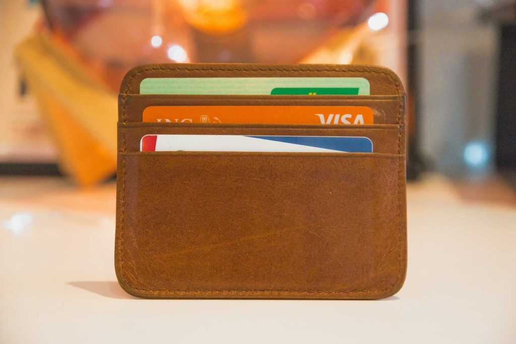 A brown cardholder with three cards