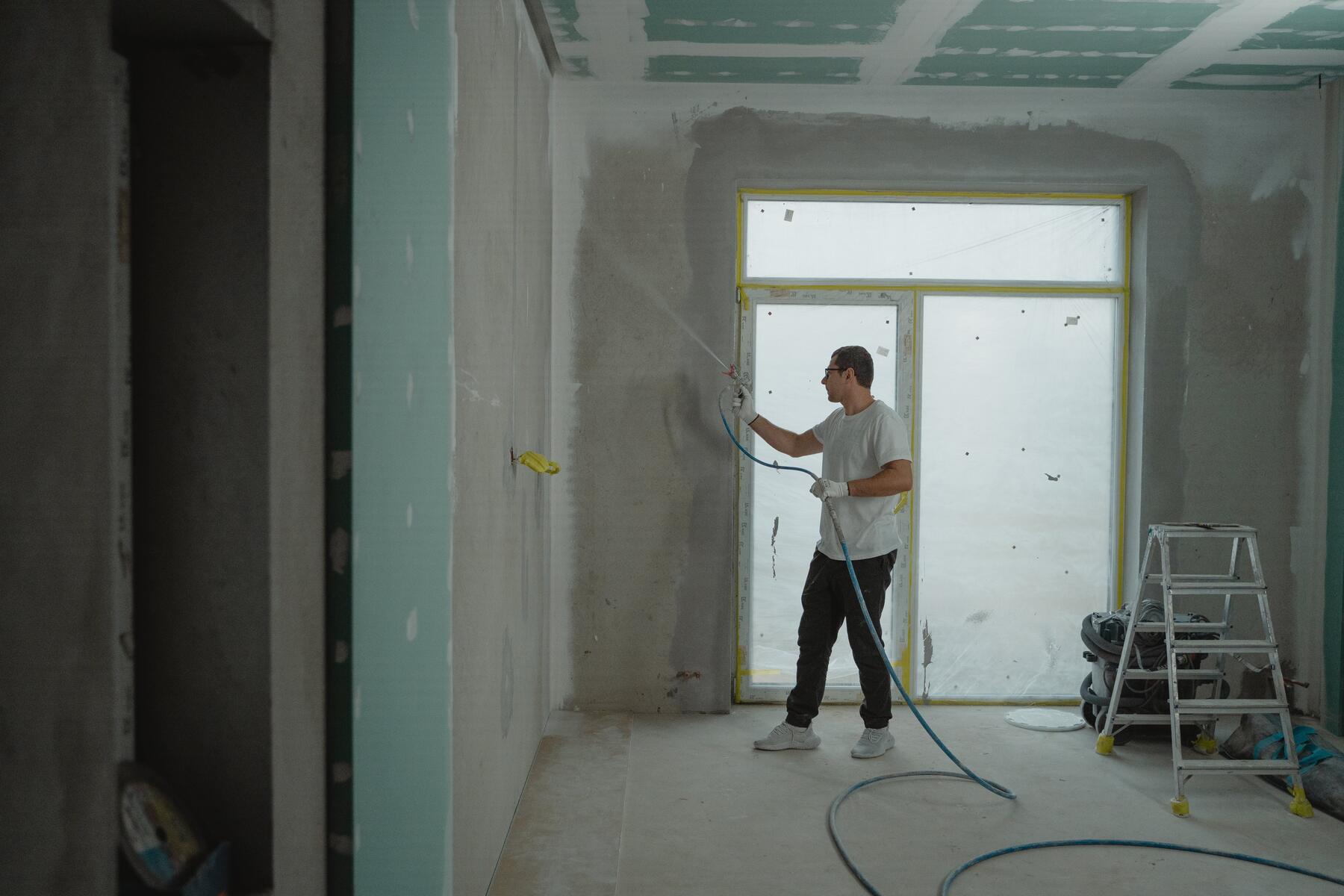 Man spray painting a wall