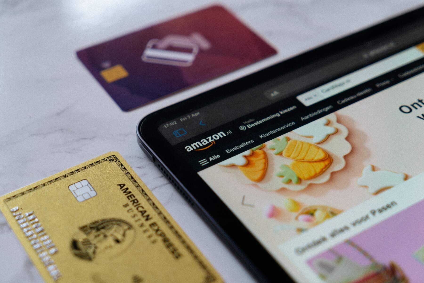 American Express card placed beside a tablet on a table