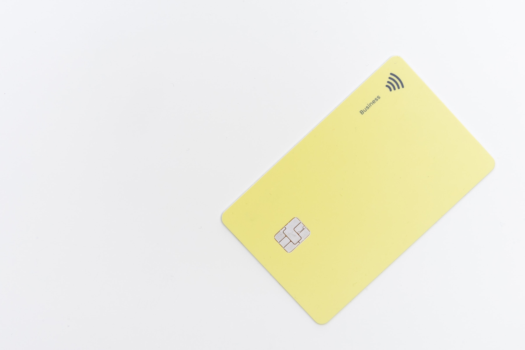 A yellow credit card on a white background