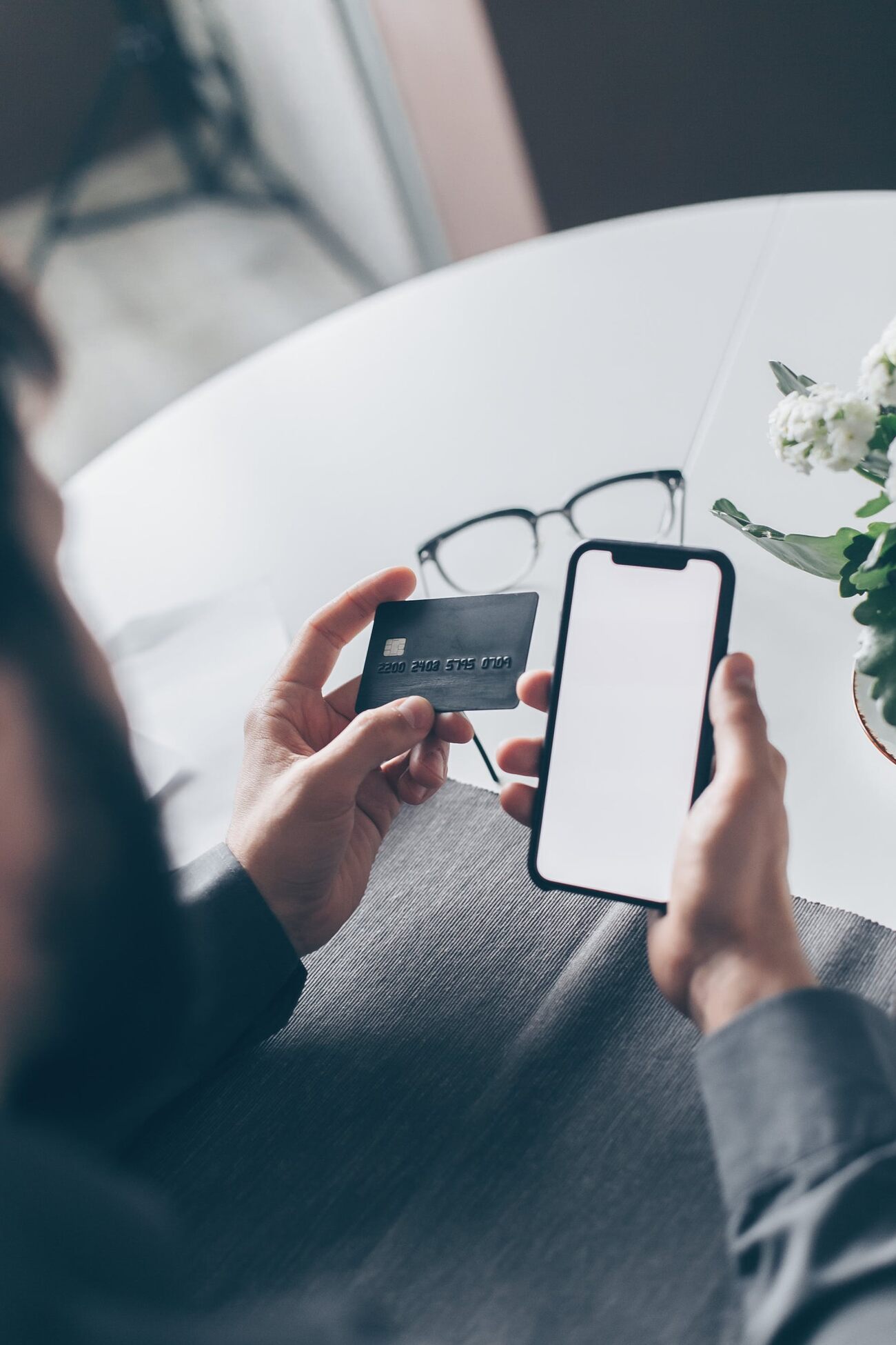 A man holding his phone and credit card