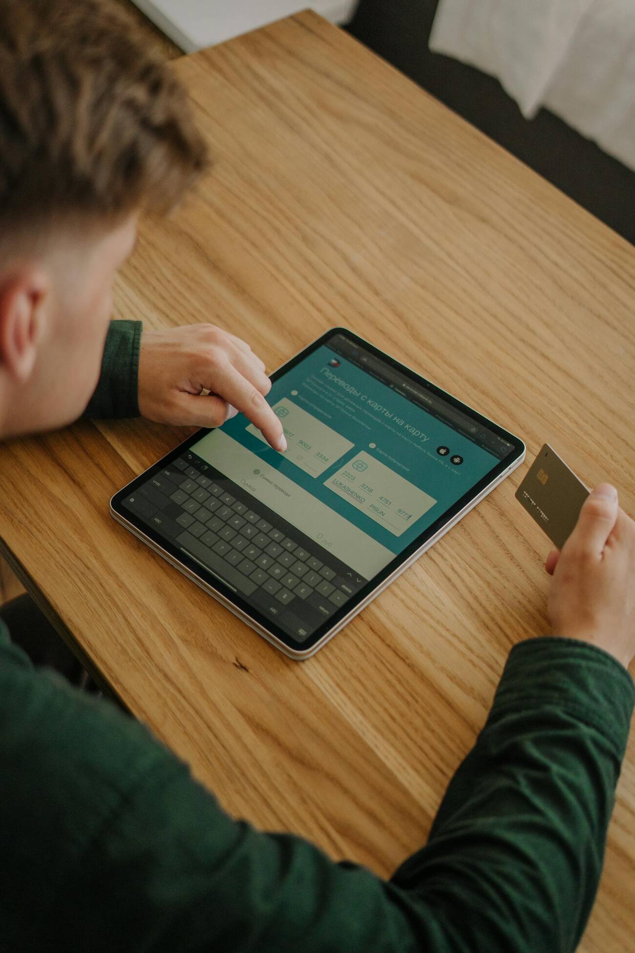 A man using a tablet to make a purchase with a credit card