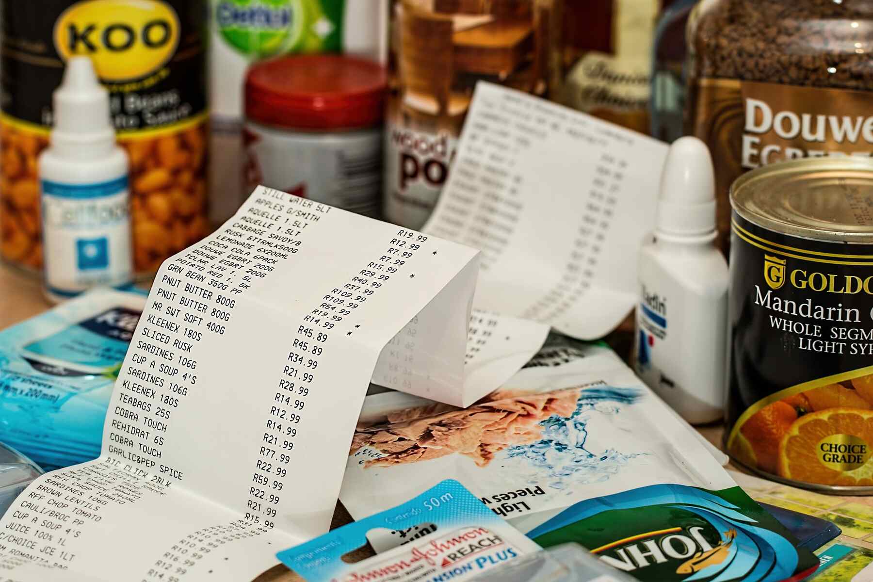 Long grocery receipt with products purchased visible on the table
