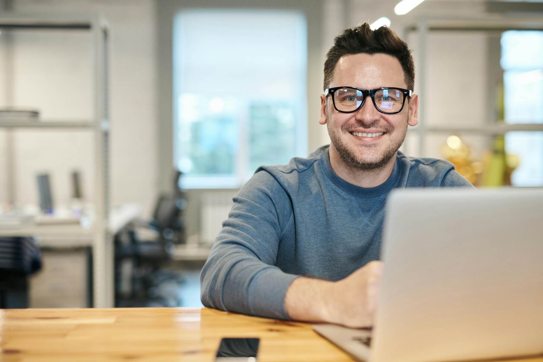 A digital marketer in front of his laptop