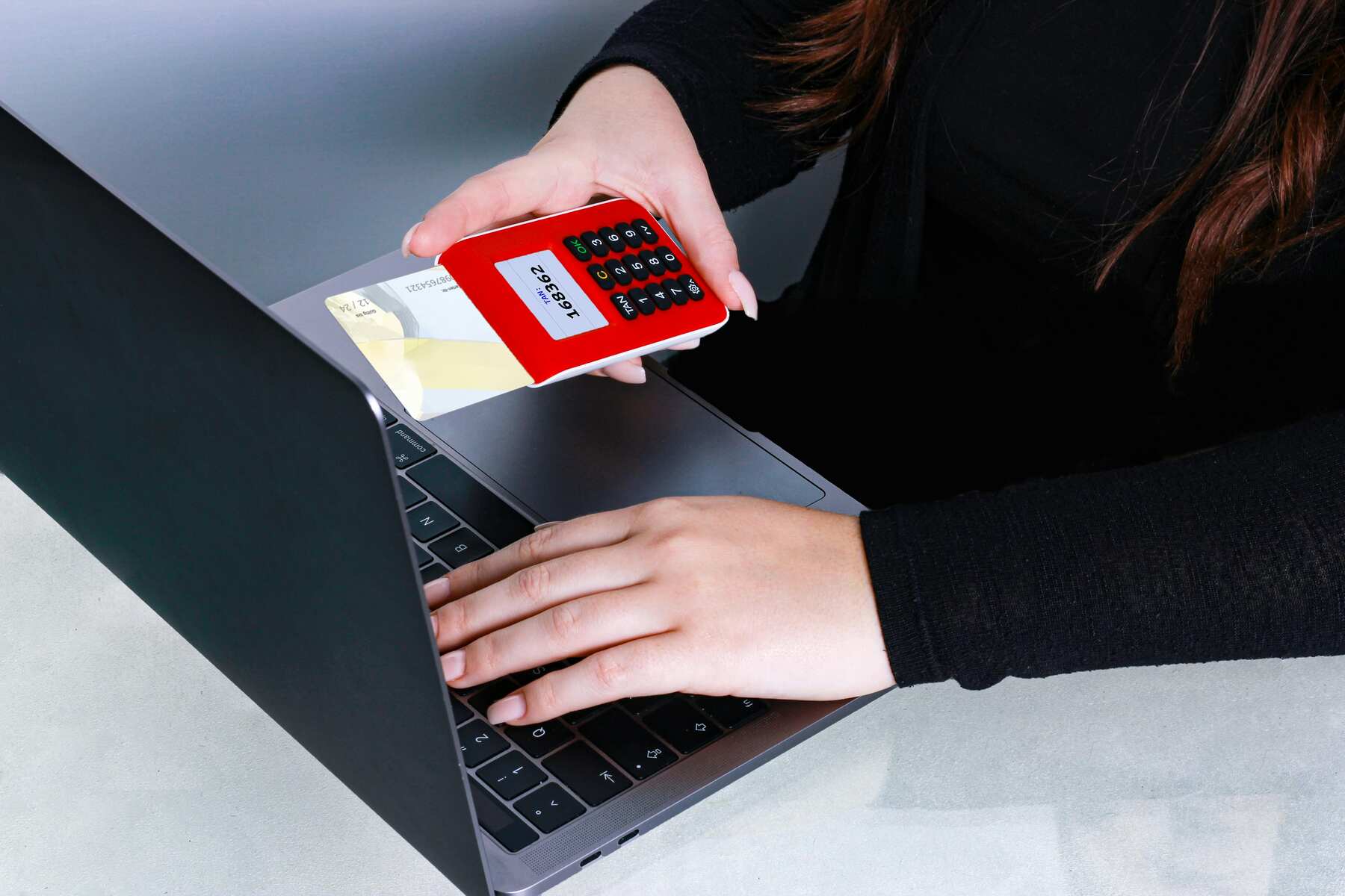 A woman holding a credit card and using online payment