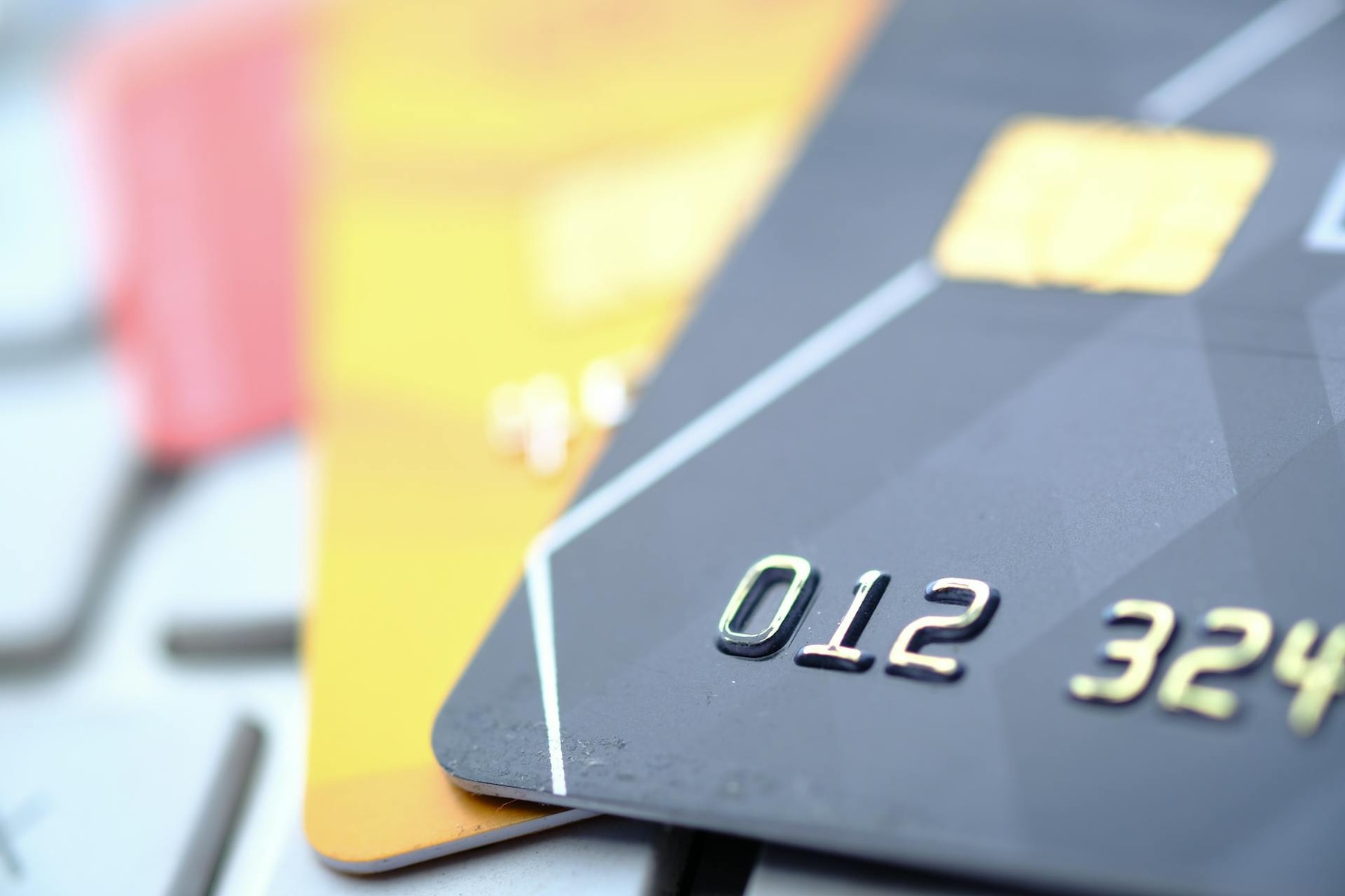 Credit cards displayed on a keyboard, representing online payments