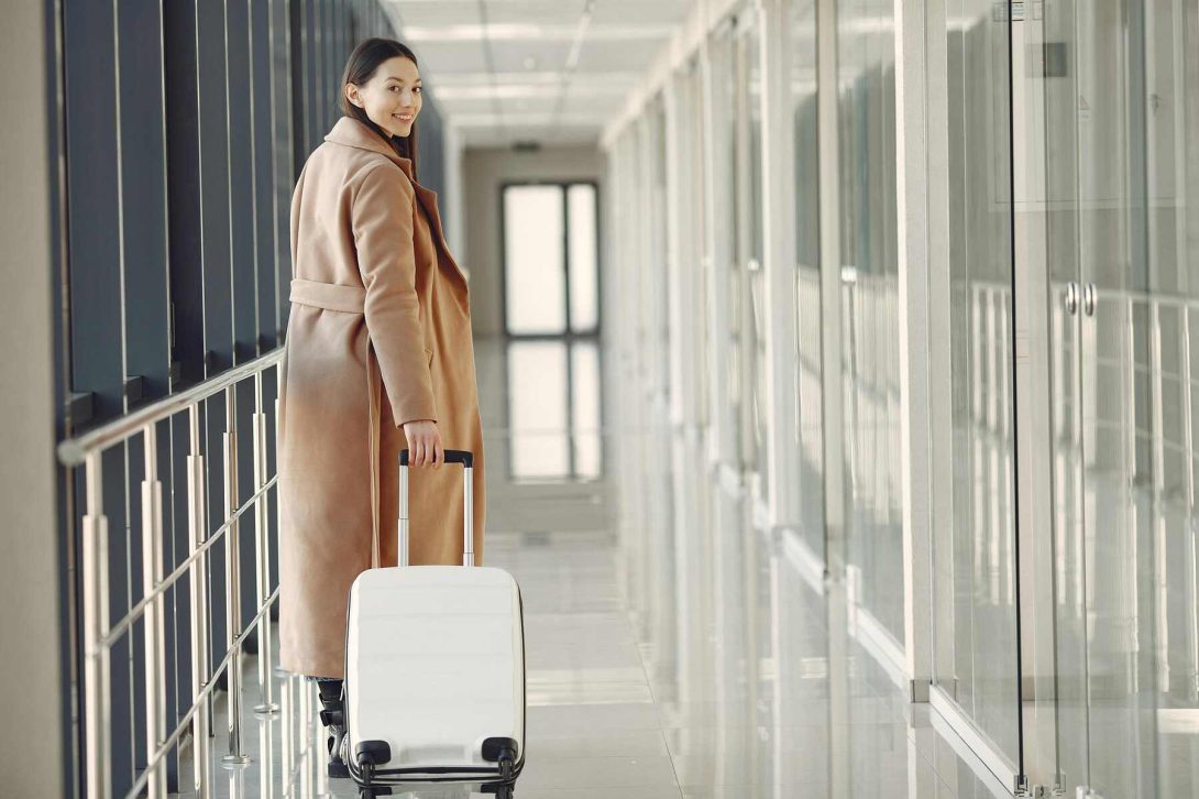 A woman pulling her baggage on the airport