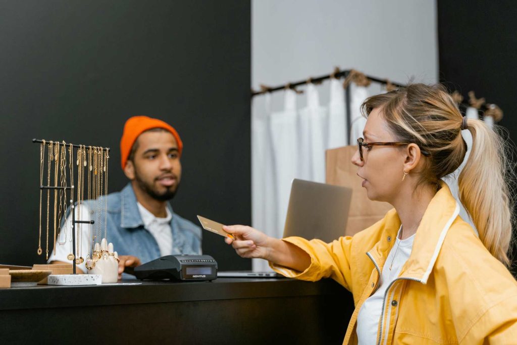 A customer paying on the store using her credit card